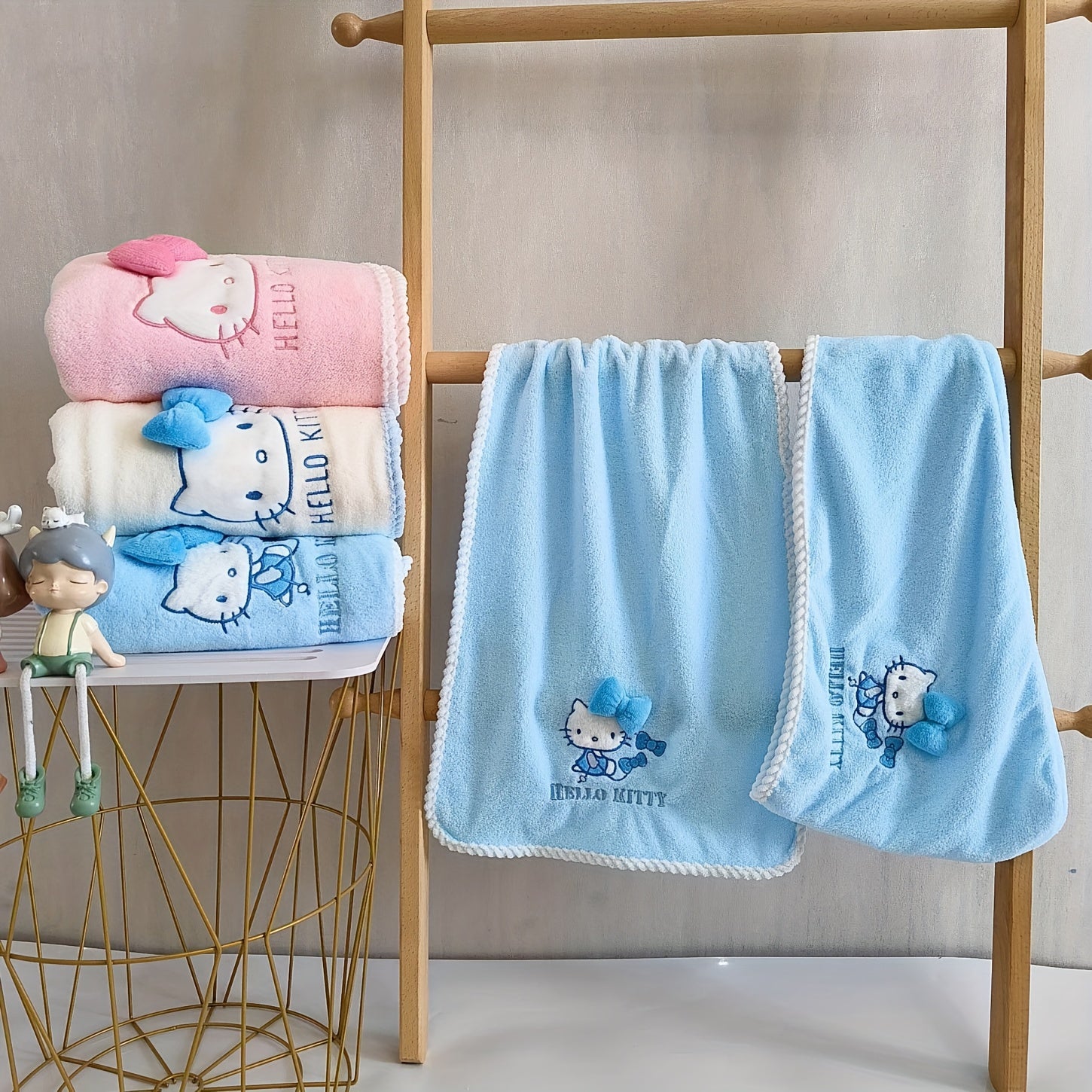 A Set of Three Sanrio Towels Themed Around for Hello Kitty, Including Bath Towels, Face Towels, And a Hair Drying Cap, All Showcasing a Three-Dimensional for Hello Kitty Design
