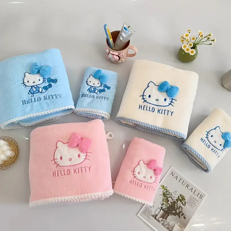 A Set of Three Sanrio Towels Themed Around for Hello Kitty, Including Bath Towels, Face Towels, And a Hair Drying Cap, All Showcasing a Three-Dimensional for Hello Kitty Design